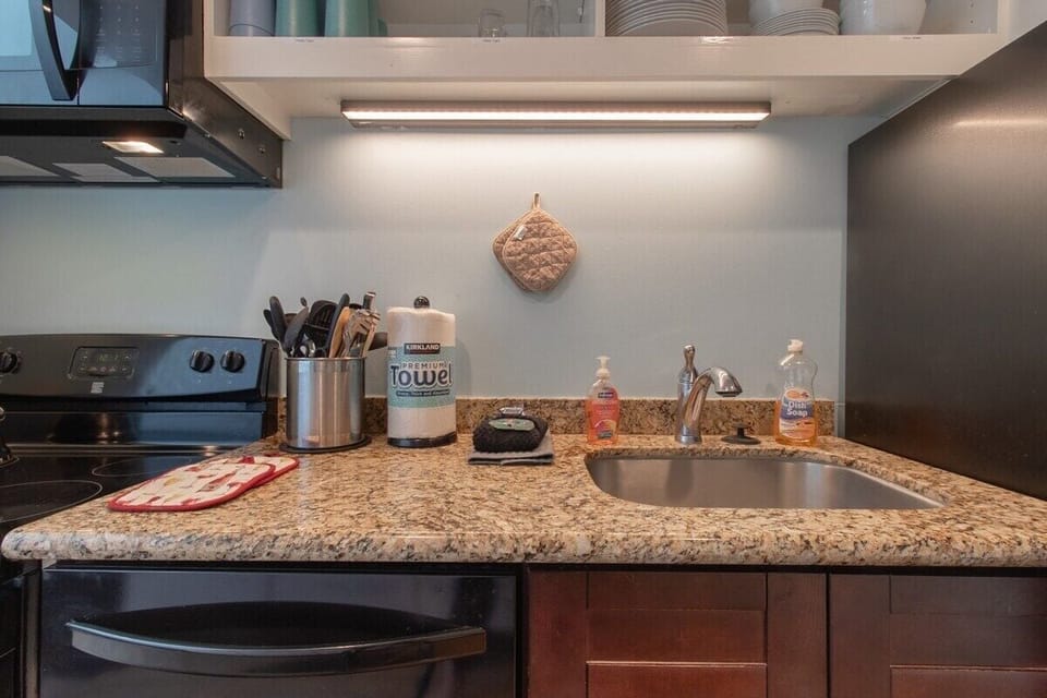 Discover the heart of the home in this beautiful kitchen area. Granite countertops, stainless steel sink, and stylish appliances create a space where you'll love to cook and entertain. Everything you need for a gourmet experience!
