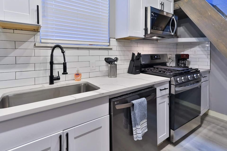 Kitchen with gas stove, sink, and prep space