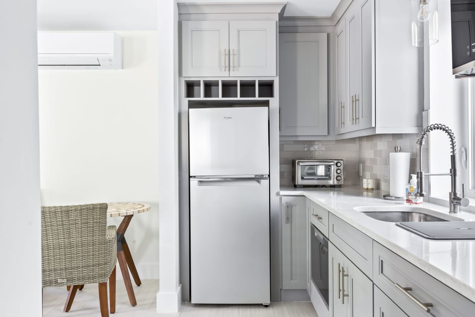 Kitchen w/ refrigerator, dishwasher, microwave, toaster oven & electric cooktop