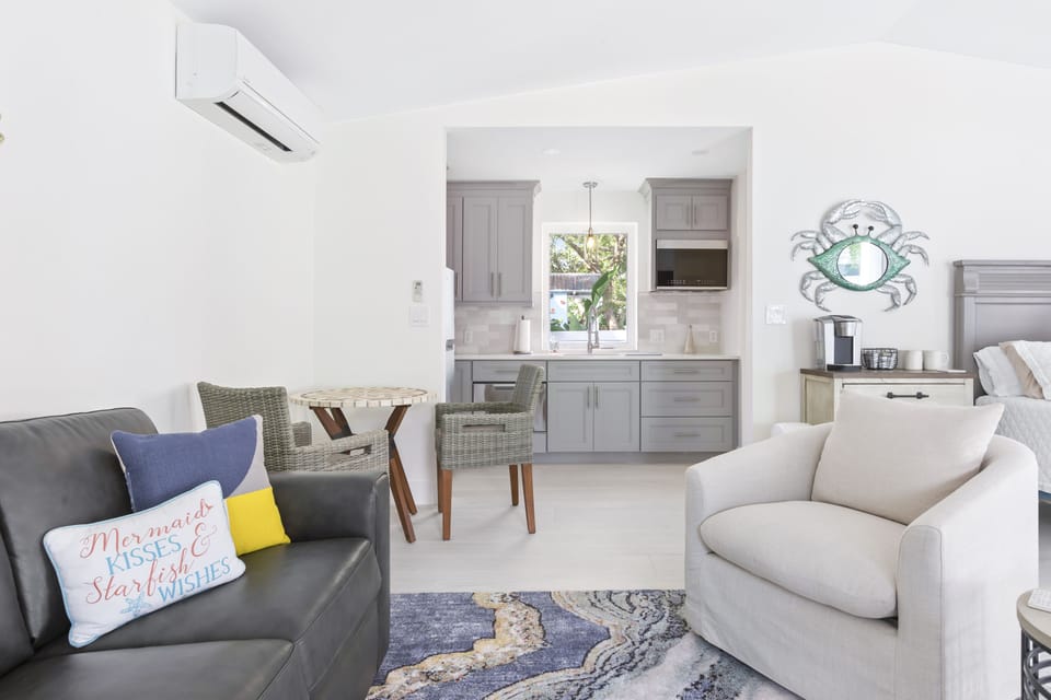 Sitting area includes two swivel chairs and leather couch