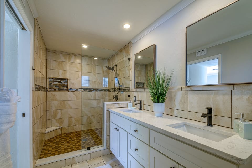 Luxurious master bath has two sinks and X- large spa shower fitted for royalty