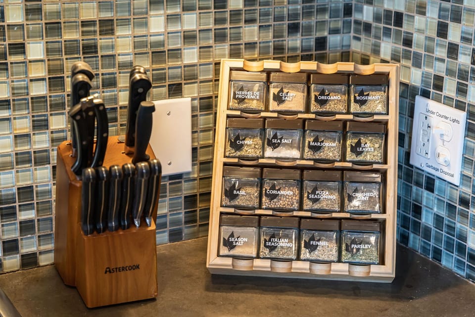 Well-stocked kitchen includes a full knife set and organized spice rack, making it easy to prepare meals just like at home.