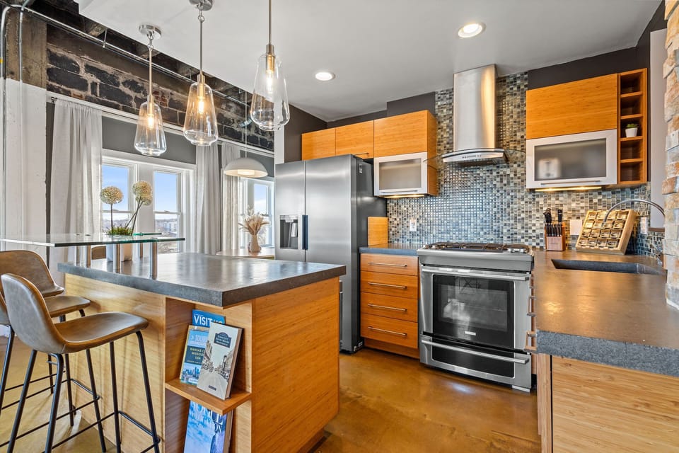 Spacious chef’s kitchen with oversized island seating, perfect for morning coffee, casual meals, or gathering with your group.