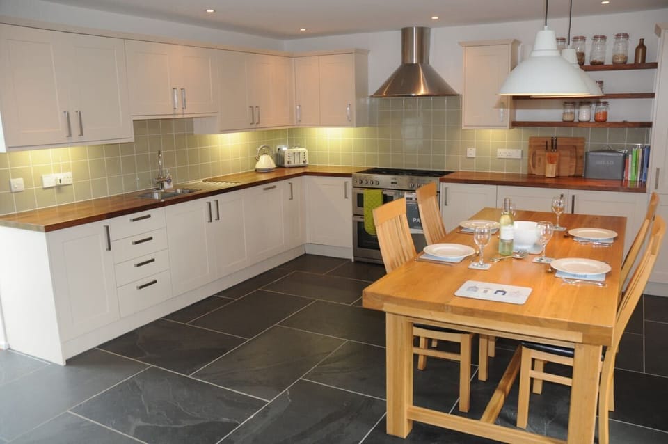 The large, well-equipped kitchen seats 6 for dining on home cuisine.