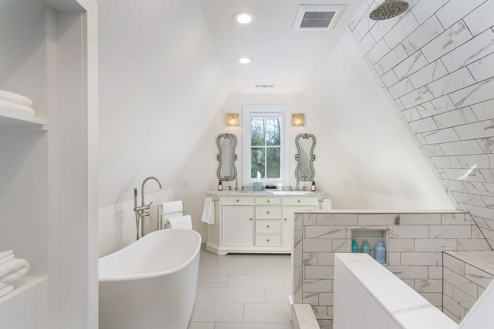 Upstairs full bathroom with unique open shower. Double vanity and bathtub.