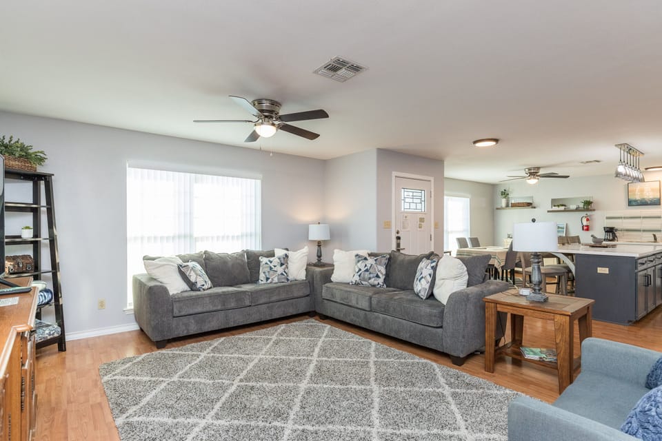 The living, dining, and kitchen areas blend seamlessly for a bright and airy feel