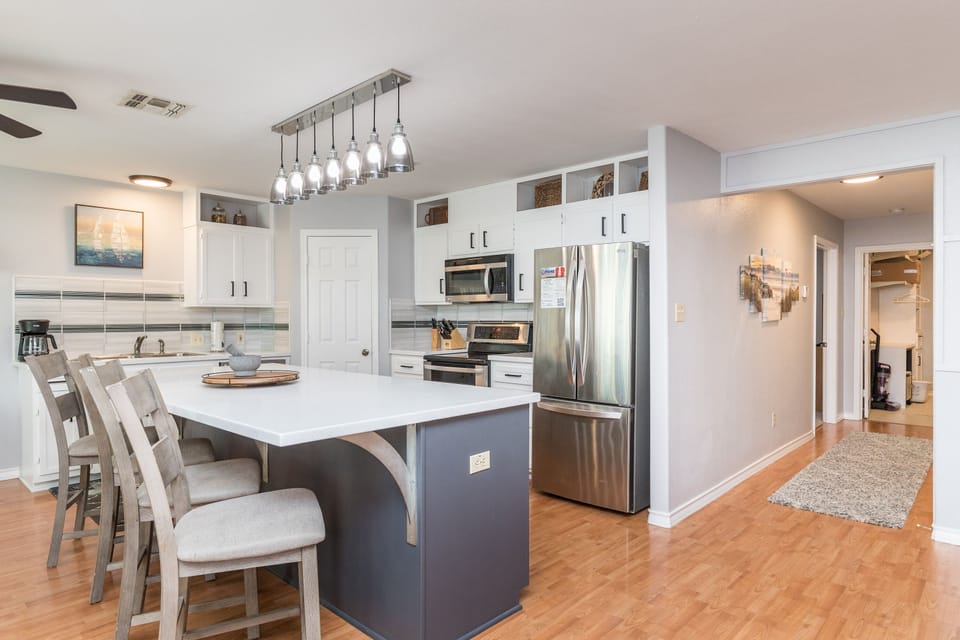 Fully equipped kitchen with stainless steel appliances and plenty of counter space to cook