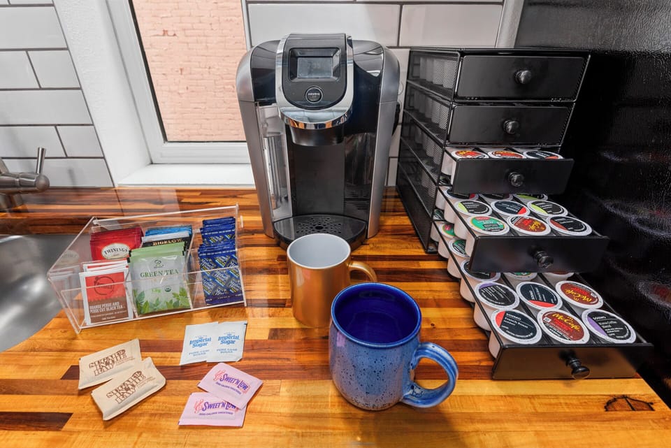 Coffee station stocked with K-Cups, cream, sugar, and morning basics