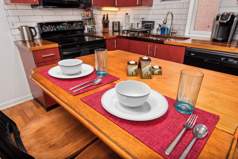 Dining table beside the fully stocked kitchen, ideal for meals or laptop time