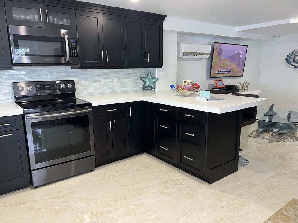 White quartz counter top with expresso wood cabinets for your enjoyment 