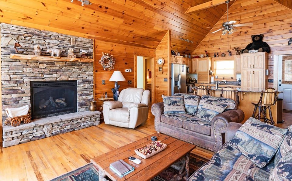 Living Room with indoor fireplace and kitchen
