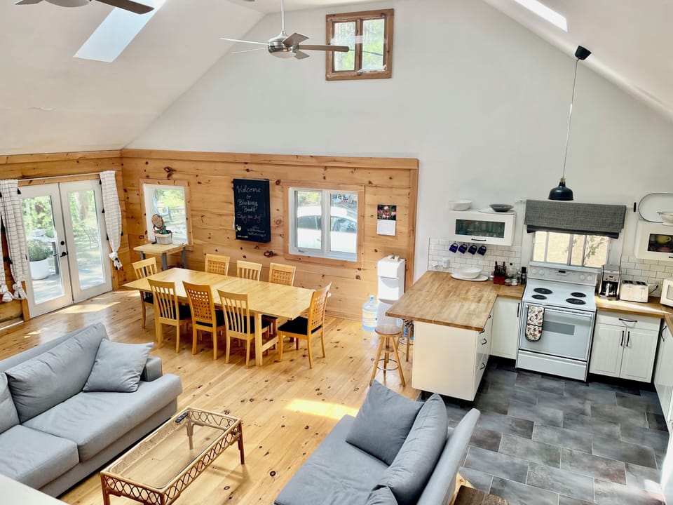 Bright open concept living area. There is also a wood burning stove to stay cozy