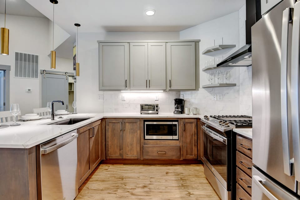 Beautiful Kitchen Includes White Granite Counters And Custom Two-Toned Wood Cabinetry