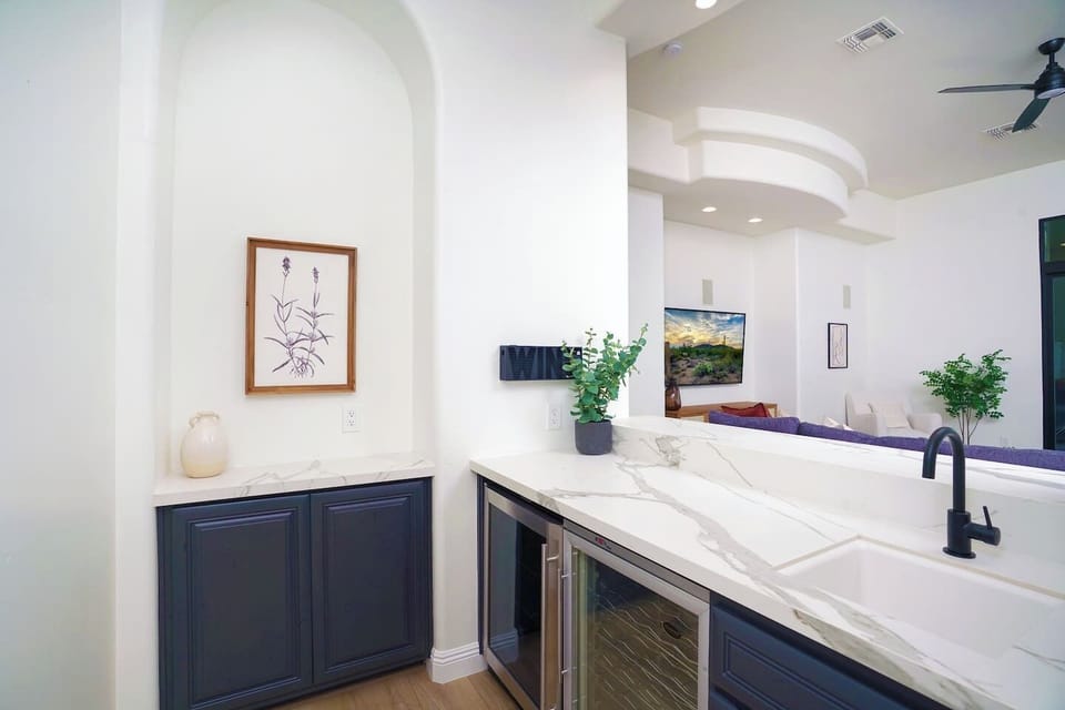 Wet bar located directly off kitchen/living room complete with multiple temp wine coolers & sink.