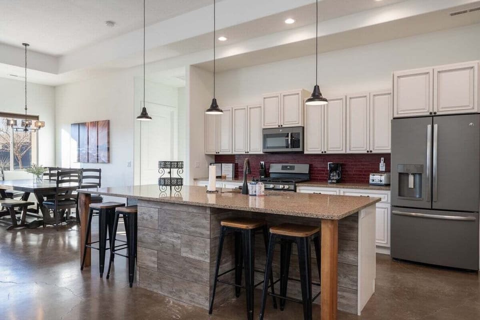 The kitchen features a rustic design with industrial accents, offering practicality and durability.