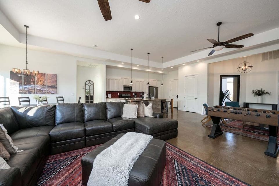 This dynamic living room and dining area is an entertainer's dream. With a stylish sectional for lounging, a foosball table for some friendly competition, it's the perfect blend of dining and play.