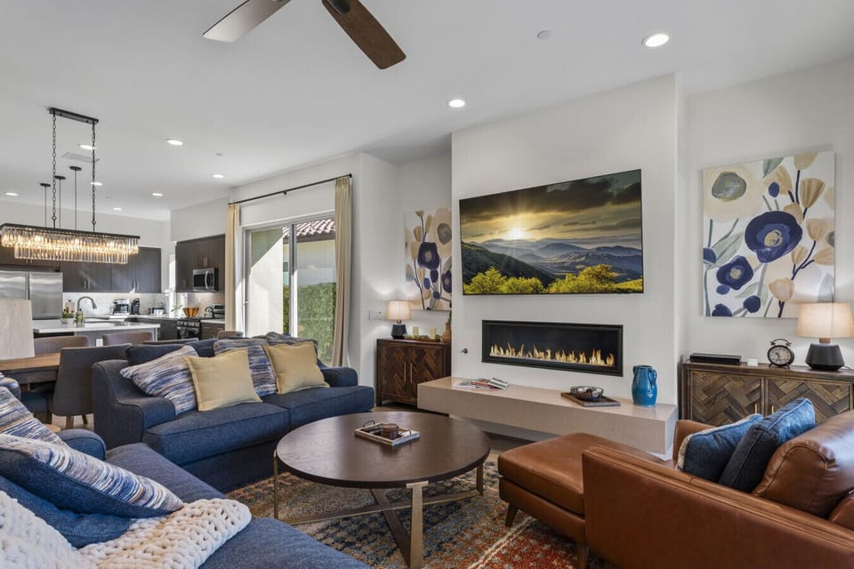 Chic living space w/ statement fireplace, comfy sofas & warm ambient lighting