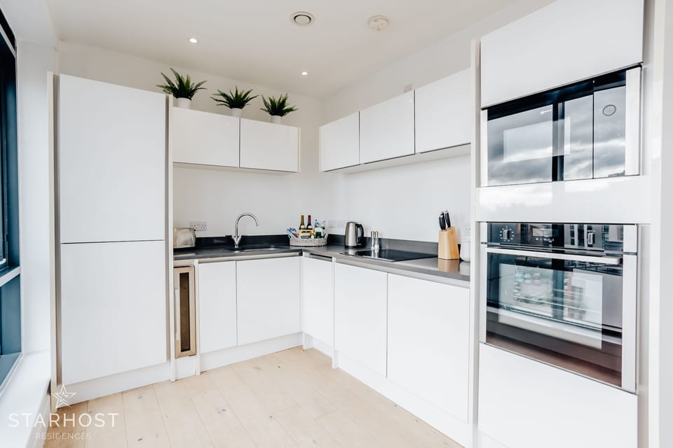 The kitchen is fully equipped with integrated appliances