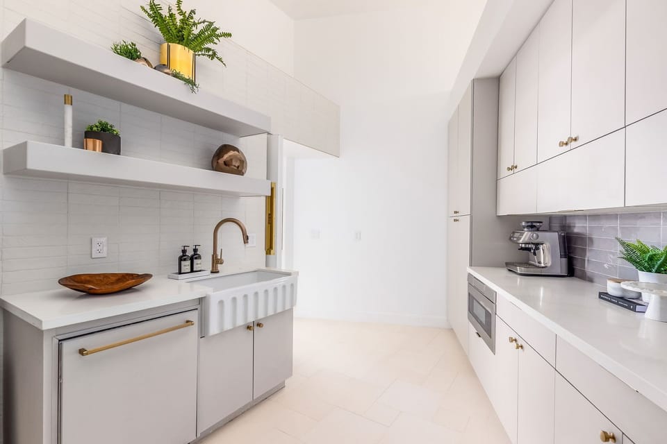 This thoughtfully designed pantry pairs style with function, offering open shelving, plenty of storage, and a charming farmhouse sink—perfect for prep work or keeping the kitchen organized.