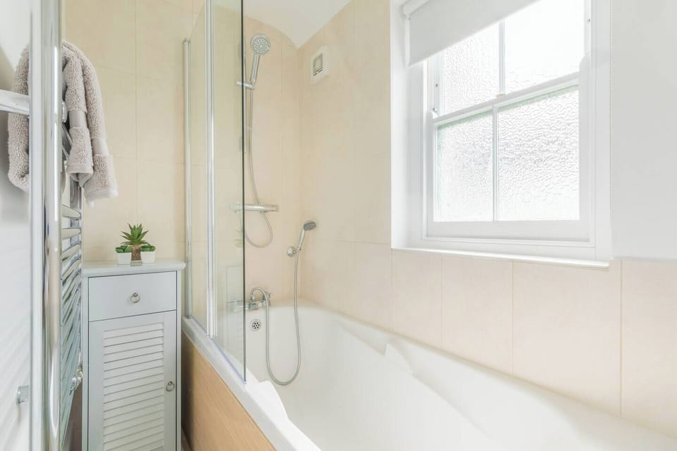 1st floor family bathroom with shower over bath, toilet & basin