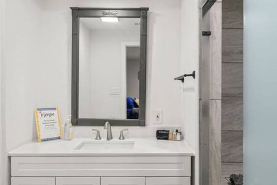 Your private bathroom features elegant white marble countertops and a spacious vanity, perfect for your morning routine.