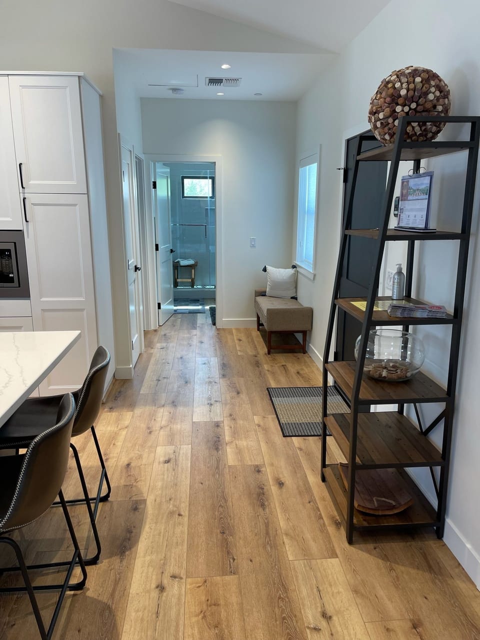Entryway with wall hooks for jackets/hats and shelf for storage.
