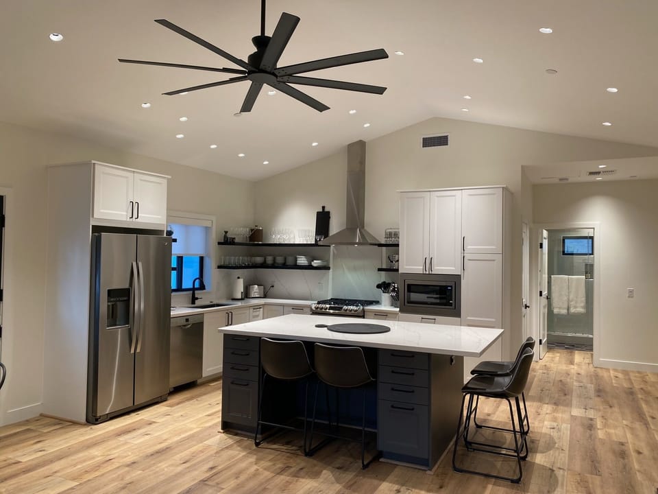 Open Kitchen, dining & living room with high ceiling and powerful fan.