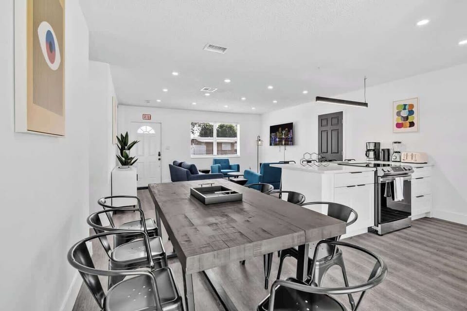 Gather in this open-plan living area with modern art, comfy seating, and a clean, contemporary vibe.