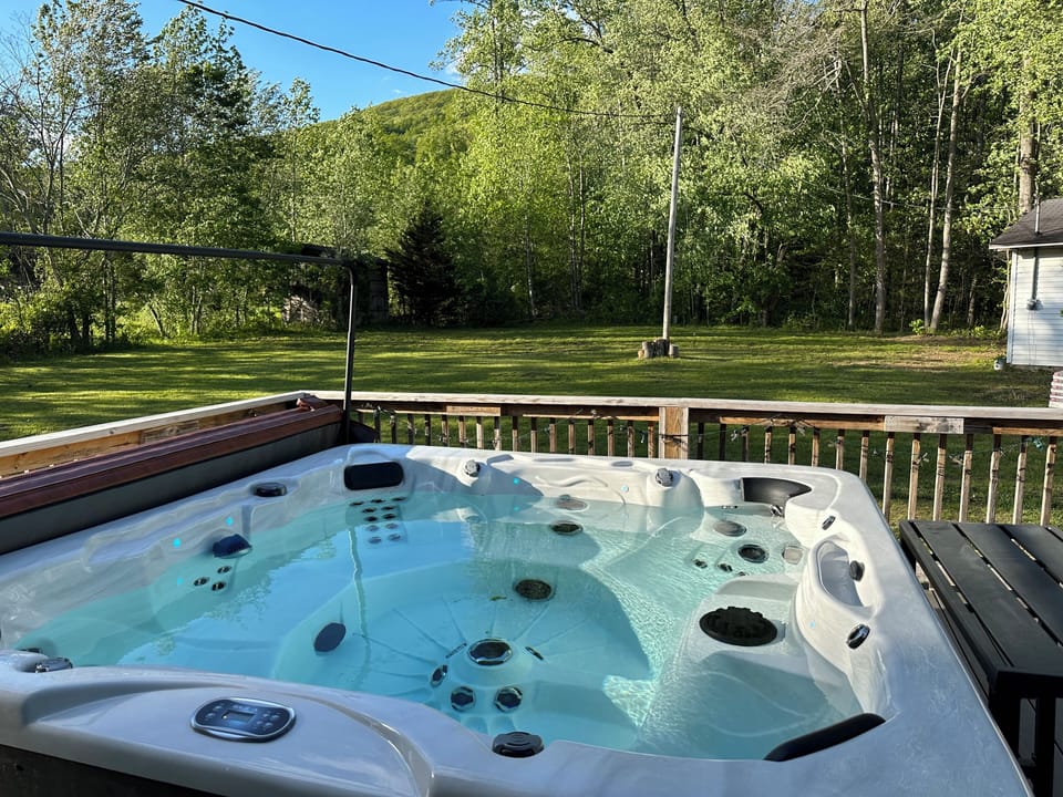 Hot tub overlooking lots of back yard.