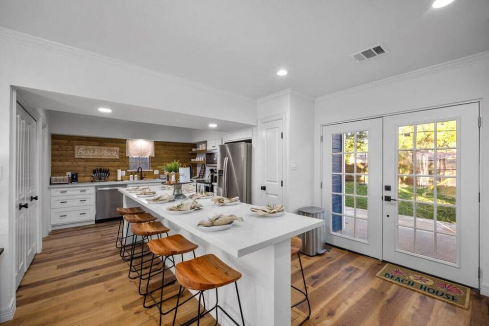 Oversized kitchen island with seating for up to 10, plus French doors leading to the backyard patio.