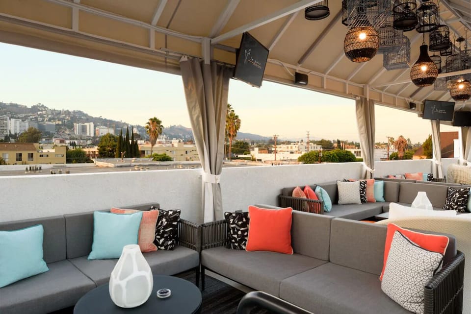 Unwind on cushioned sofas as the city glows beyond.