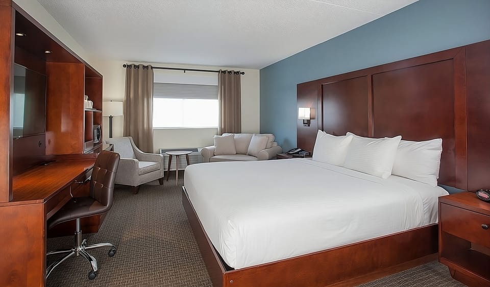Settle into crisp linens beside a convenient work desk.