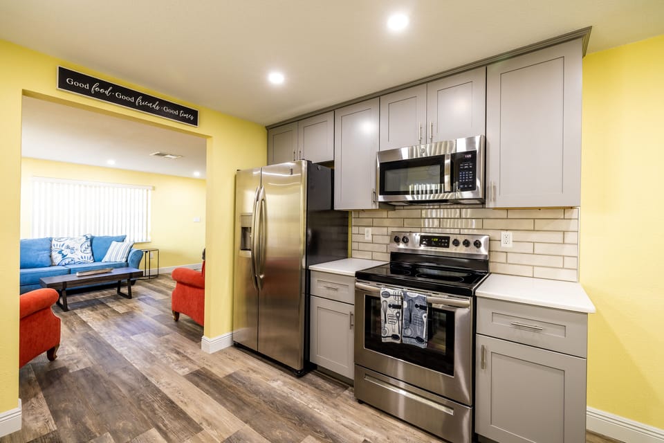 The kitchen features quartz countertops and stainless appliances.