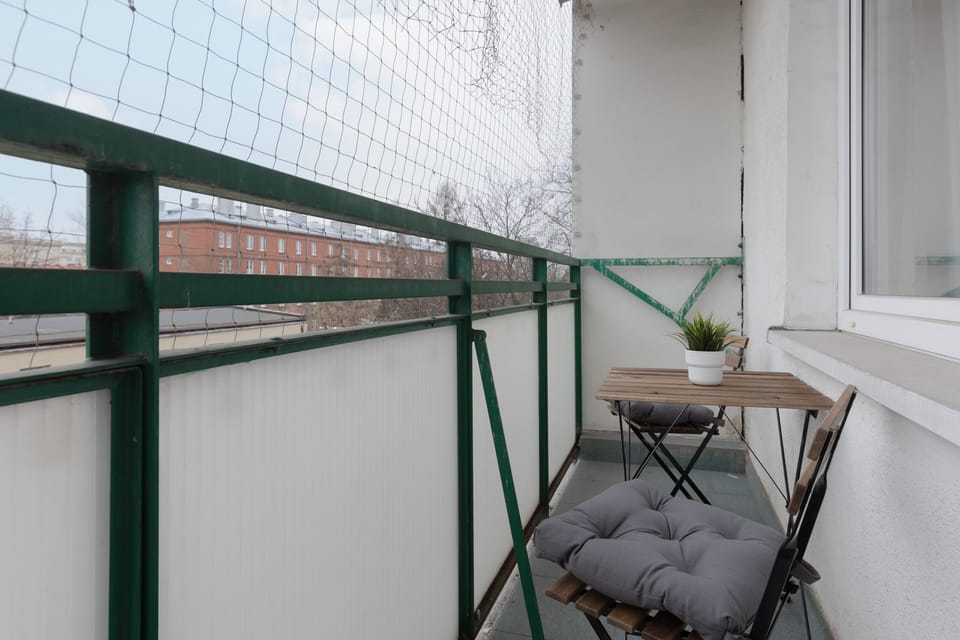 A cozy balcony with seating, perfect for enjoying fresh air and relaxation.
