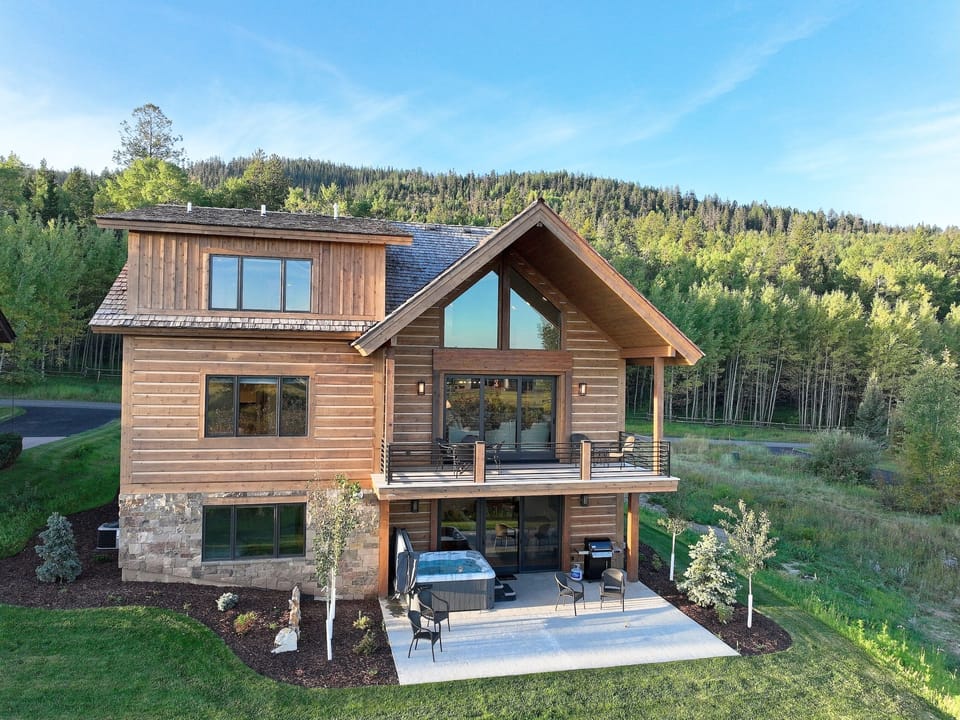 Your mountain retreat awaits with stunning forest views and a private hot tub on the patio. Feel the warmth of natural wood and stone as you unwind in this peaceful sanctuary.