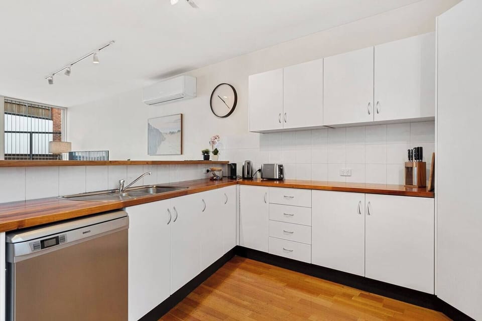 The spacious kitchen is fully equipped to prepare meals at home including ample prep space and a dishwasher for easy cleanup.