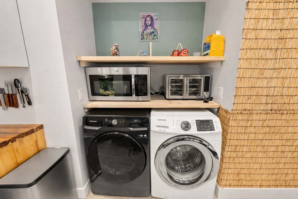 In-Unit Washer and Dryer with Open Shelving and Storage — Convenient Laundry Setup Designed for Easy, Comfortable Resort Living