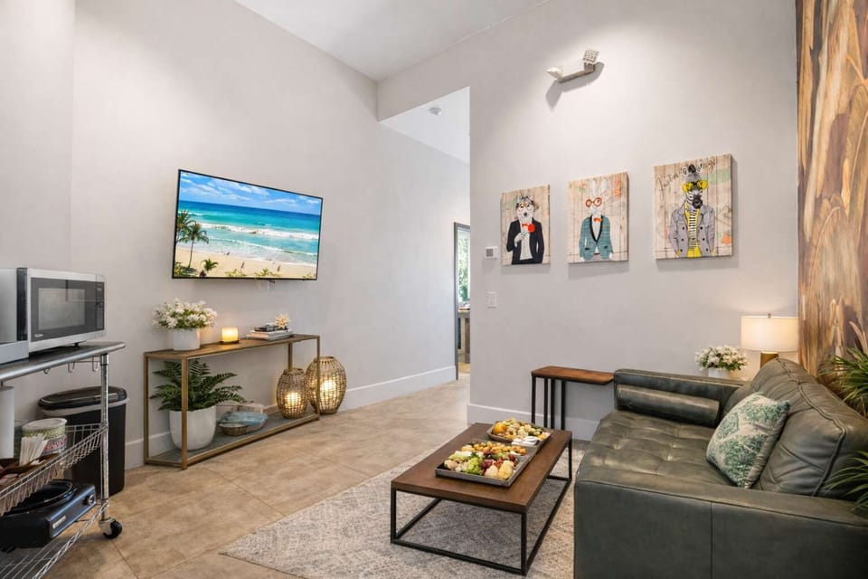 Stylish Lounge Area with Tropical Wall Art, Cozy Seating & Warm Ambient Lighting Creating a Relaxed Resort Vibe