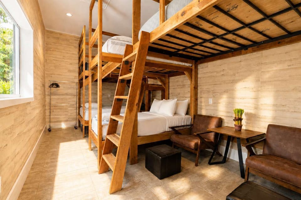 Bedroom with Custom Bunk Bed, Warm Wood Finishes, and Cozy Seating Area