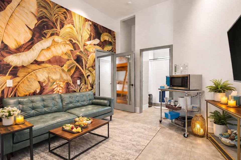 Stylish Lounge Area with Tropical Wall Art, Cozy Seating & Warm Ambient Lighting Creating a Relaxed Resort Vibe