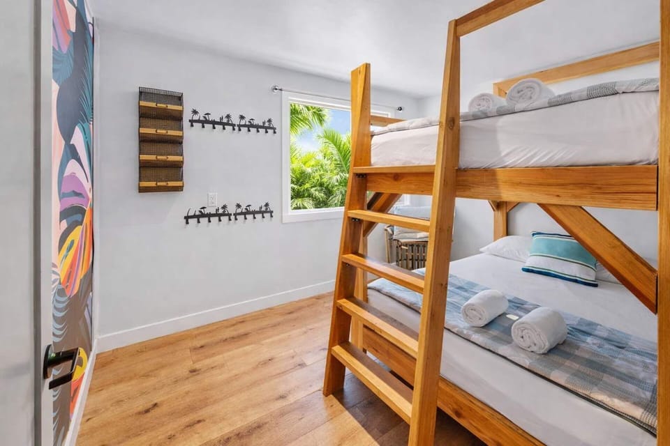 Bright Bunk Room with Solid Wood Beds, Surf-Inspired Decor, and Clean Coastal Comfort