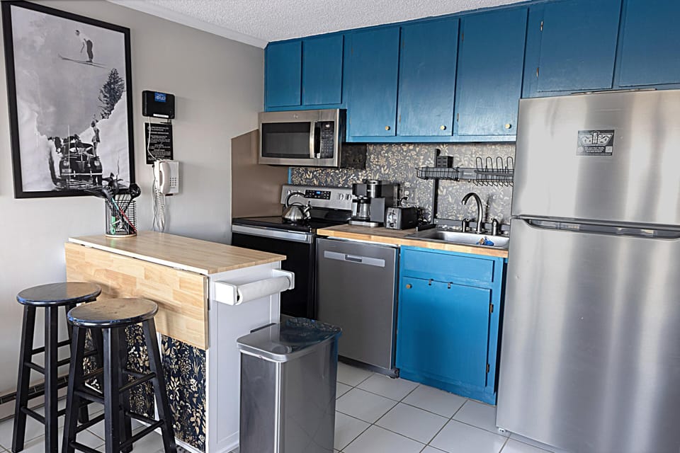 The kitchen features stainless steel appliances and comes fully equipped—perfect for whipping up a quick snack or preparing a full meal!