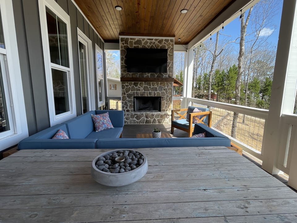 Upstairs outdoor seating area and wood-burning fireplace with propane starter.