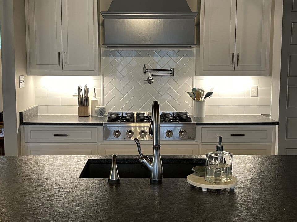 Kitchen with gas stove, pot filler, touch faucet.