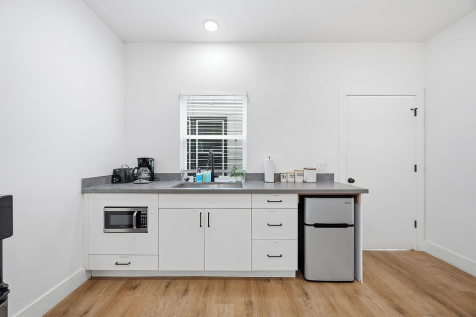Basic amenities: microwave, mini fridge, coffee maker, water dispenser and toast