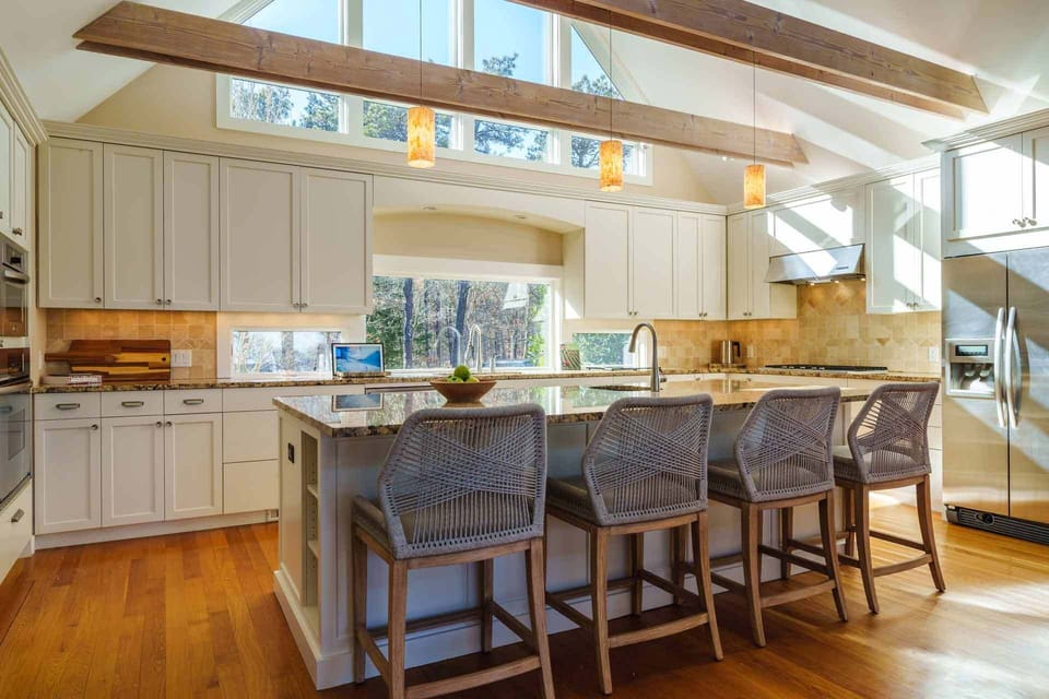 Kitchen Has a Center Island with a Sink and Breakfast Bar with 4 Bar Stools