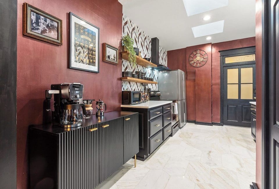This fully equipped kitchen offers stainless-steel appliances, open shelving, and vintage-inspired décor that blends classic charm with modern convenience.