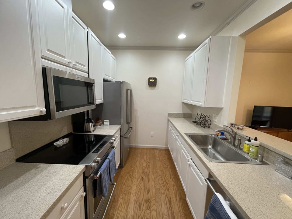 The kitchen has plenty of counterspace, plus all the appliances and kitchenware you need