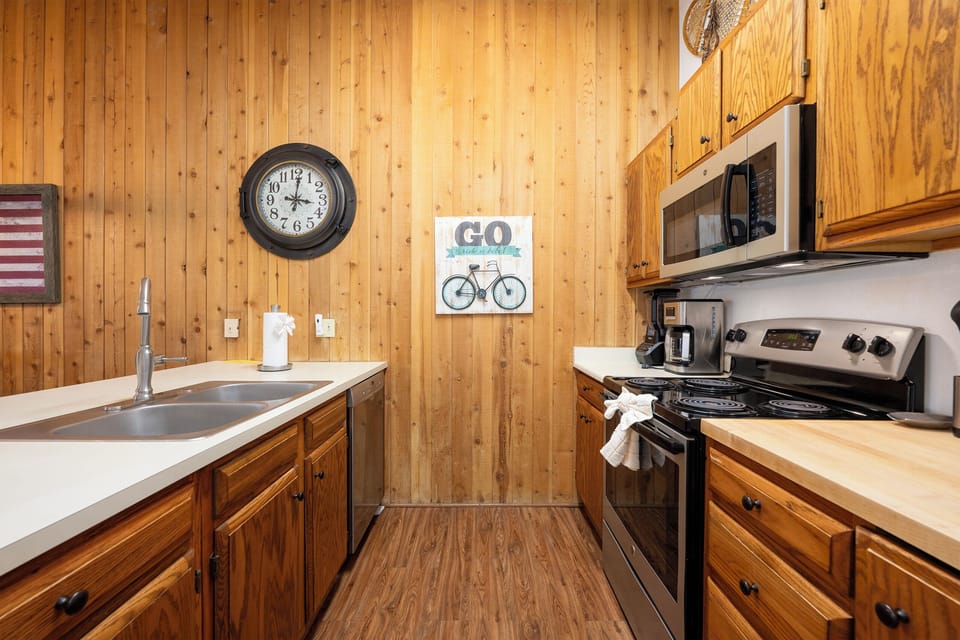 Your fully-equipped kitchen features warm wood cabinets, modern appliances, and rustic charm for memorable meal prep.