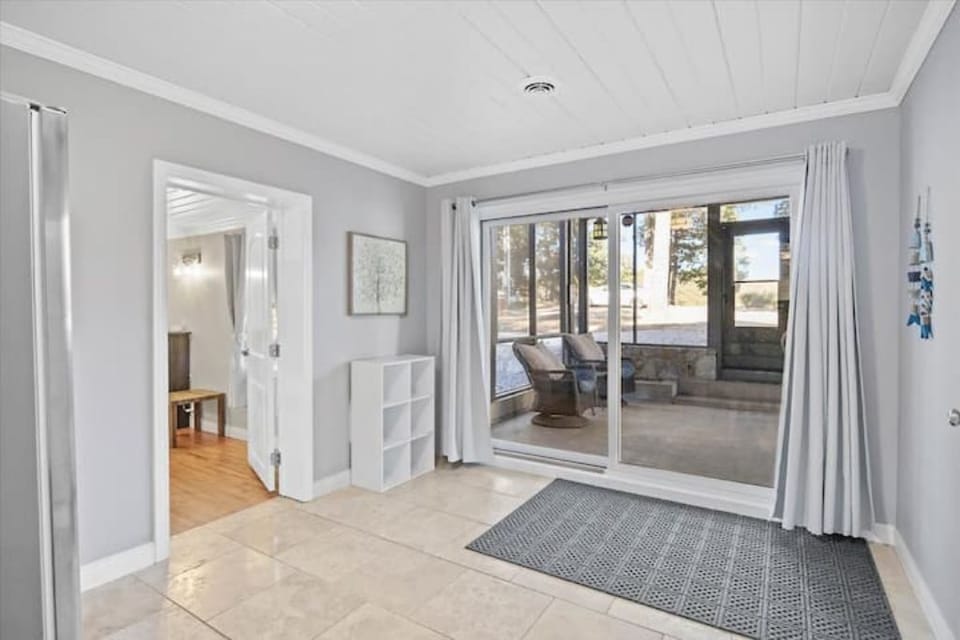 Hallway has additional full-sized refrigerator and leads to screened porch.